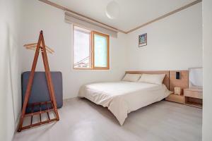 a bedroom with a bed and a ladder in it at Stay ongyeol in Suwon