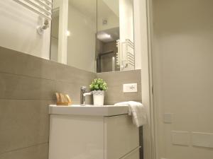 a bathroom with a sink and a mirror at 8 Colonne Apartments in Bologna