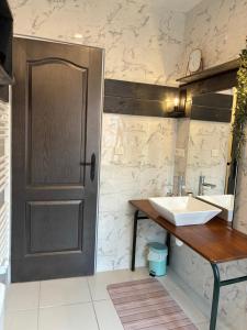 a bathroom with a sink and a door at Le 36 du prieuré in Arbois +26 photos