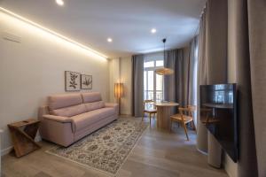 a living room with a couch and a table at Apartamento Nova by Cartagena Spain in Cartagena