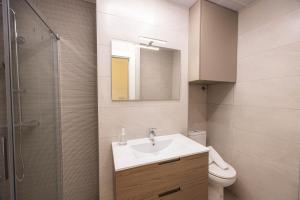 a bathroom with a sink and a toilet and a mirror at Apartamento Nova by Cartagena Spain in Cartagena +38 photos