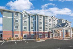 a large building with a parking lot in front of it at Microtel Inn & Suites by Wyndham Ocean City in Ocean City