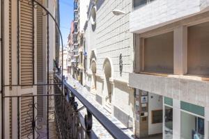 an alley between two buildings on a city street at Apartamento Nova by Cartagena Spain in Cartagena