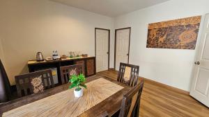 a dining room with a wooden table and chairs at Baan Glang Soi Restaurant & Guesthouse in Bangkok