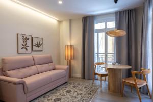 a living room with a couch and a table at Apartamento Nova by Cartagena Spain in Cartagena