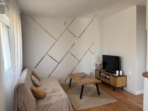 a living room with a couch and a television at Casa del Sol - Santiago de la Ribera, San Javier, 600 m from the beach, swimming pool in San Javier