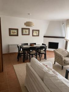 a living room with a table and chairs and a couch at Badaguás in Badaguás