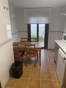 a kitchen with a table and chairs in a room at Badaguás in Badaguás +2 photos