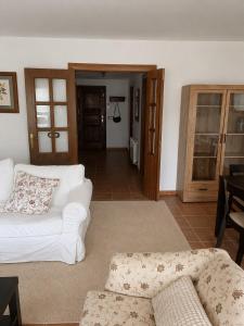 a living room with two white couches and a table at Badaguás in Badaguás