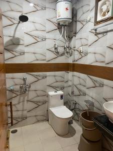 a bathroom with a toilet and a sink at Nanda niwas 2 in McLeod Ganj