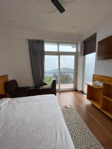 a bedroom with a bed and a large window at Nanda niwas 2 in McLeod Ganj
