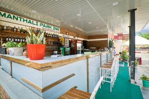 a restaurant with a counter with chairs and a bar at Manthali Park Inn in Rāmechhāp