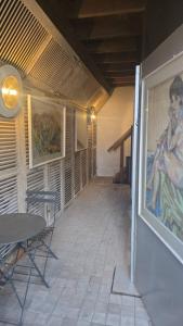 a patio with a table and a painting on the wall at zeer ruim appartement in Zottegem