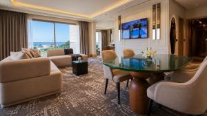 a living room with a glass table and chairs at Grand Dominium in Agadir