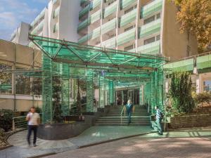 people standing in front of a building at Hotel Carbona Thermal Spa in Hévíz