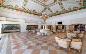 a hotel lobby with a chandelier and a fountain at Nirvana Dolce Vita - Ultra All Inclusive in Tekirova