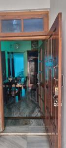an open door to a dining room with a table at Gyan Nivas in Bareilly