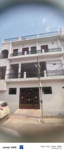 a white building with a door in front of it at Gyan Nivas in Bareilly