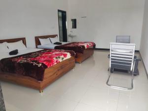 two beds sitting in a room with a mirror at Jyoti Hotel and Restaurant in Desuri
