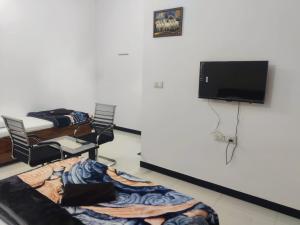 a room with a bed and a flat screen tv at Jyoti Hotel and Restaurant in Desuri