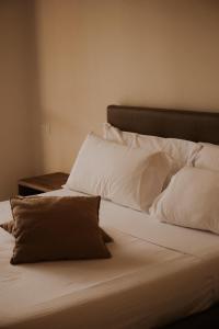 a bed with white sheets and pillows on it at Tursport in Taranto +35 photos