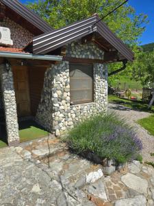 a stone house with a window in a yard at COUNTRY HOUSE in Bihać