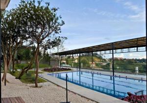 a swimming pool with a pavilion next to a building at Dalabiang Hotel in Da Lat