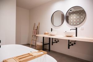 a bathroom with two sinks and a mirror at De Viervoeters Hoeve in Ruiselede +66 photos