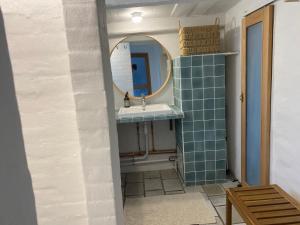 a bathroom with a sink and a mirror at Byhus Bogense in Bogense
