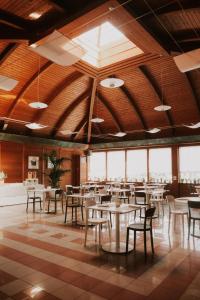 a dining room with tables and chairs and windows at Tursport in Taranto