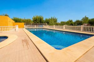 a large swimming pool with a white fence around it at Kampaoh Oliva in Oliva