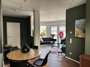 a living room with a table and chairs at Ostwall Terrassen Apartment in Bocholt
