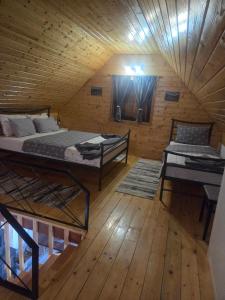 a room with two beds in a wooden cabin at Brvnara K2 KONAK in Šljivovica
