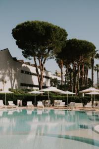 a large swimming pool with chairs and umbrellas at Tursport in Taranto