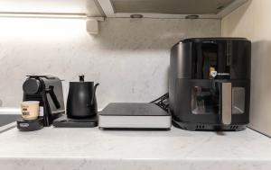 a kitchen counter with a coffee maker and a coffee pot at Nonna Konstantina- old town center in Lefkada