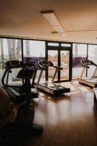 a gym with several tread machines in a room at Tursport in Taranto