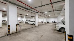 a large parking garage with cars parked in it at Hotel 3 Leaves, Kolhapur in Kolhapur