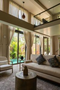 a living room with a couch and a table at The Ten in Siolim