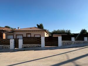 a house with a fence in front of a street at TAYP LaParra Homes in La Parra