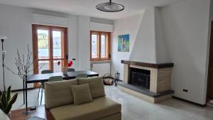 a living room with a couch and a fireplace at Attico 14 in Castel di Sangro