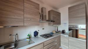 a kitchen with wooden cabinets and a stove top oven at Attico 14 in Castel di Sangro
