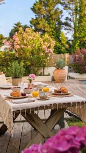 a picnic table with food and drinks on it at Chambre avec Piscine Maison EtxeCosy in Bidart