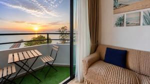 a balcony with a couch and a view of the ocean at Mutiara Melaka Beach Resort Condominium,Pantai Puteri Melaka in Malacca