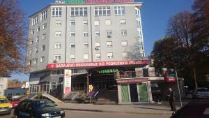 a large white building on the corner of a street at Hotel Piramida Sunca in Visoko