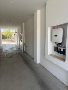 an empty hallway with a paper towel dispenser on a wall at Serendipity in Elmas