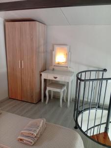 a bedroom with a desk and a bed with a lamp at Studio Mare in Nea Kallikrateia
