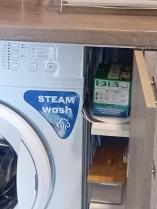 a washing machine with a sign that says steam wasatch at Studio Mare in Nea Kallikrateia