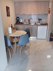 a kitchen with a table and chairs in a room at Studio Mare in Nea Kallikrateia