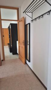 an empty hallway with a door and a mirror at Attico 14 in Castel di Sangro +12 photos