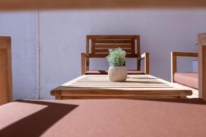 a table with a vase with a plant on it at GuestReady - Doctor House in Horta +121 photos